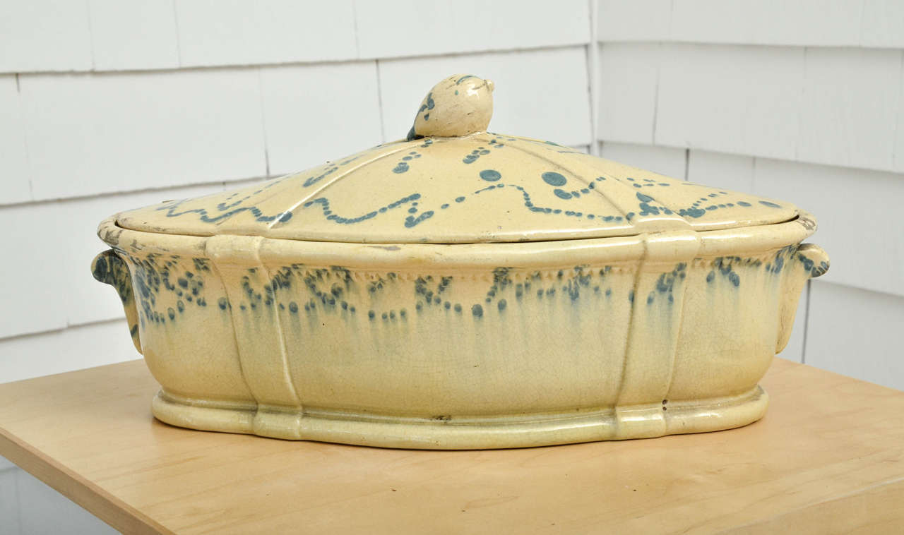 Pale yellow glazed tureen with blue spatter decoration.
